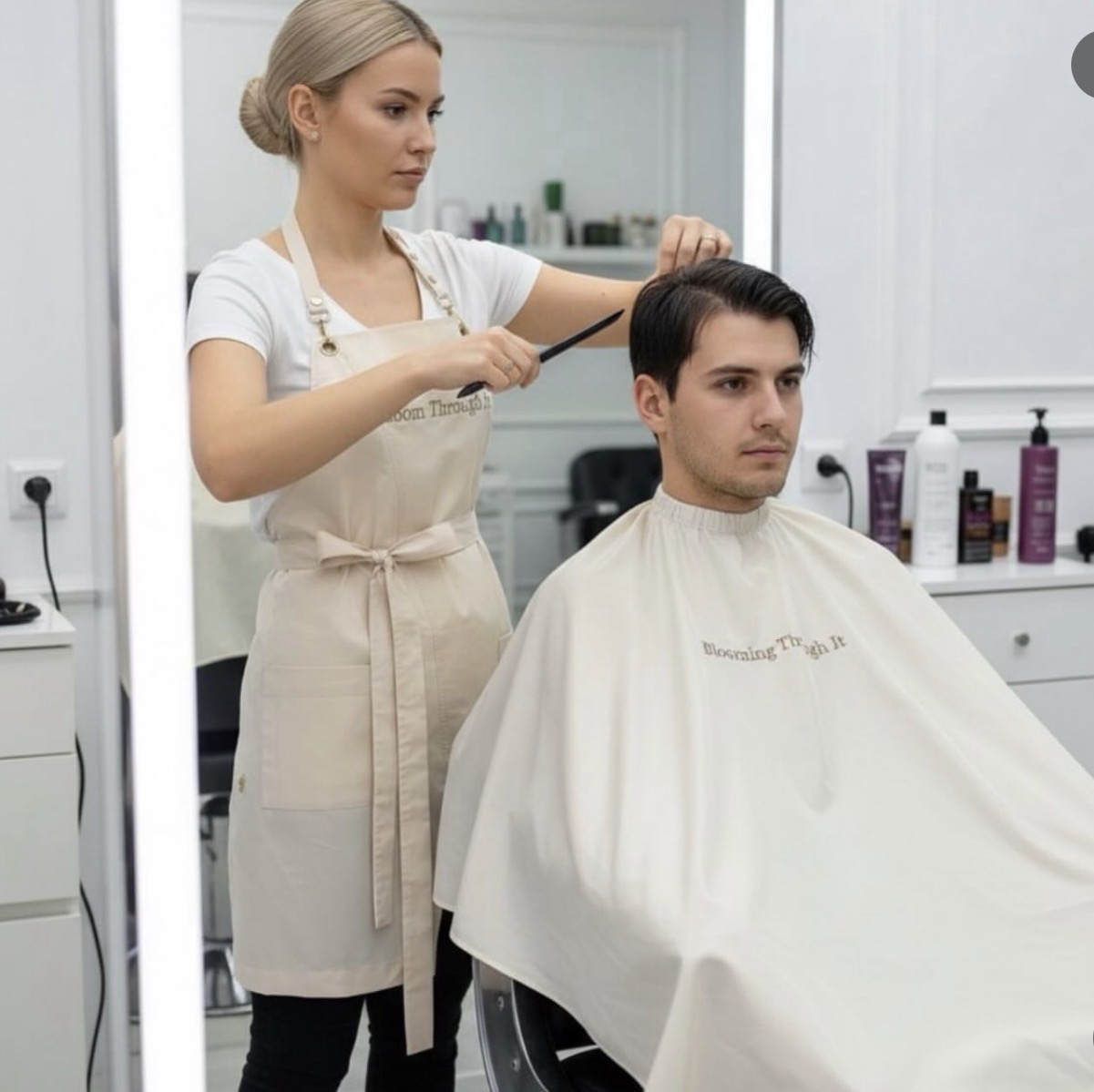 Beauty specialist in an MBL Wear apron working in the salon
