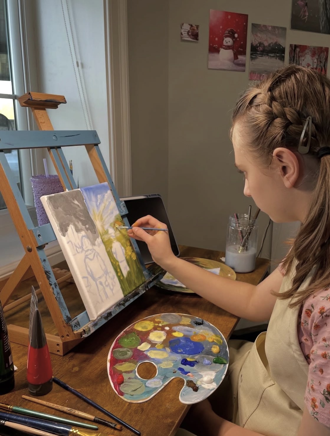 Sofia painting at her easel