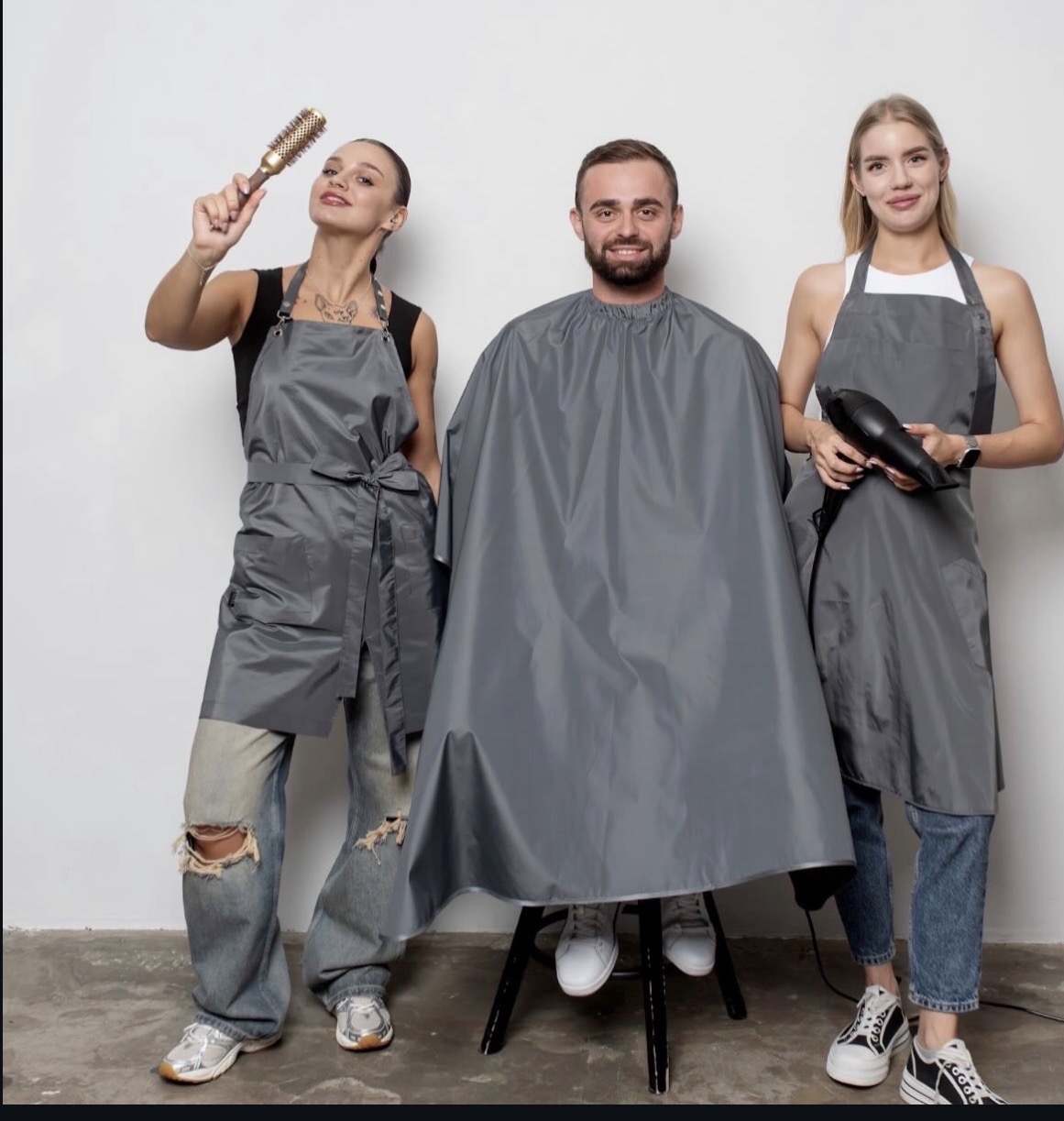MBL Wear team in gray professional aprons and capes