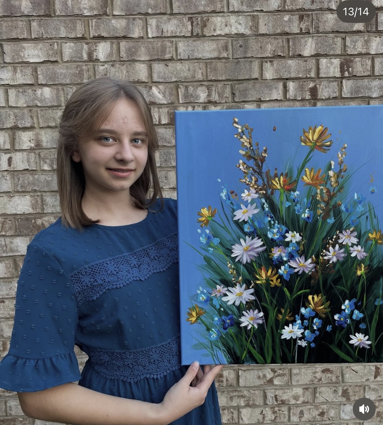 Sofia holding her wildflowers painting