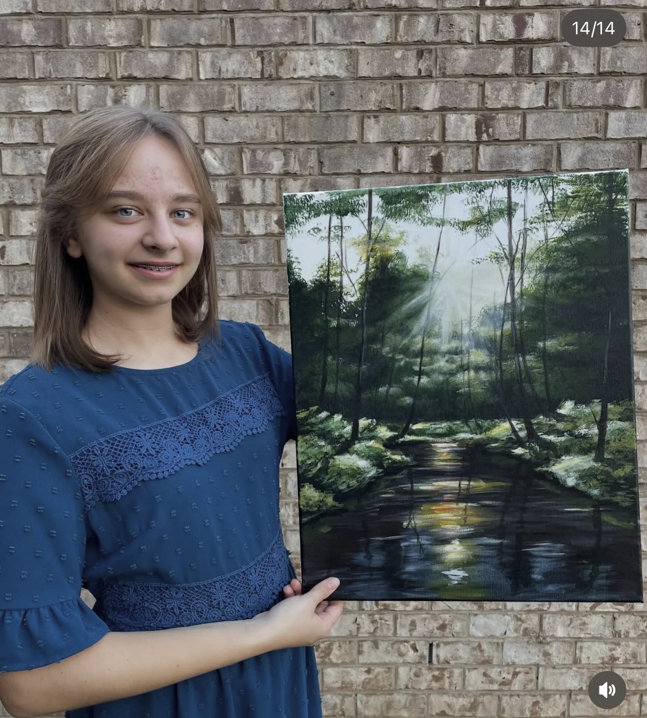 Sofia holding her forest landscape painting