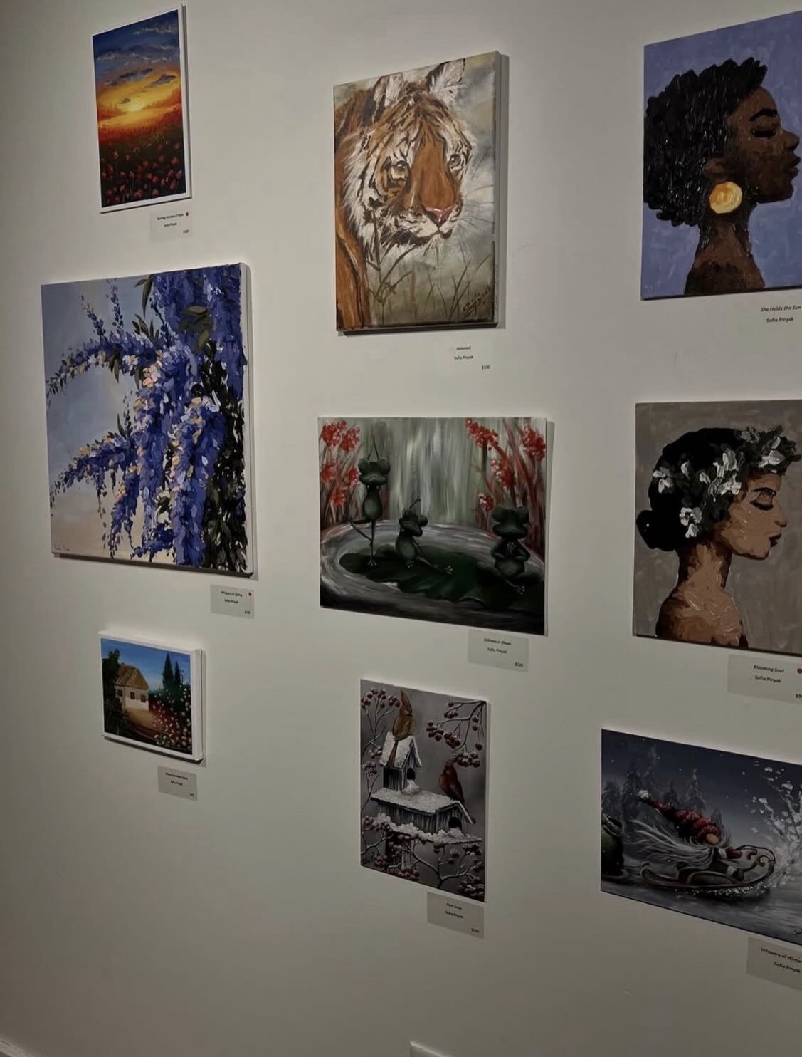 A wall of Sofia's paintings at the Ukrainian artists exhibition